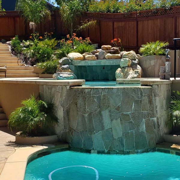 stone work on pool water feature